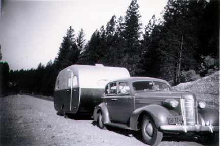 1942 18ft Mainliner travel trailer towed by a 1937 Oldsmobile V8